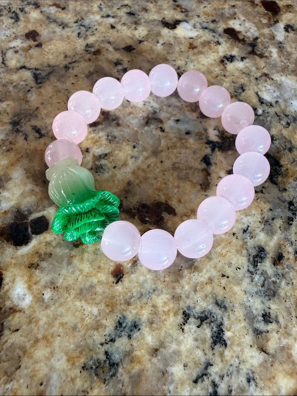 Pink Beaded Bracelet with Green Flower Accent